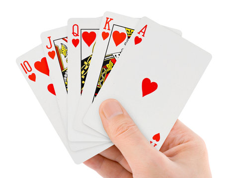 A hand of playing cards being sorted.
