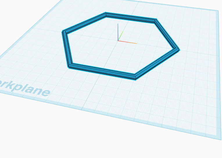 A large, thin hexagon ring lying flat on the workplane.