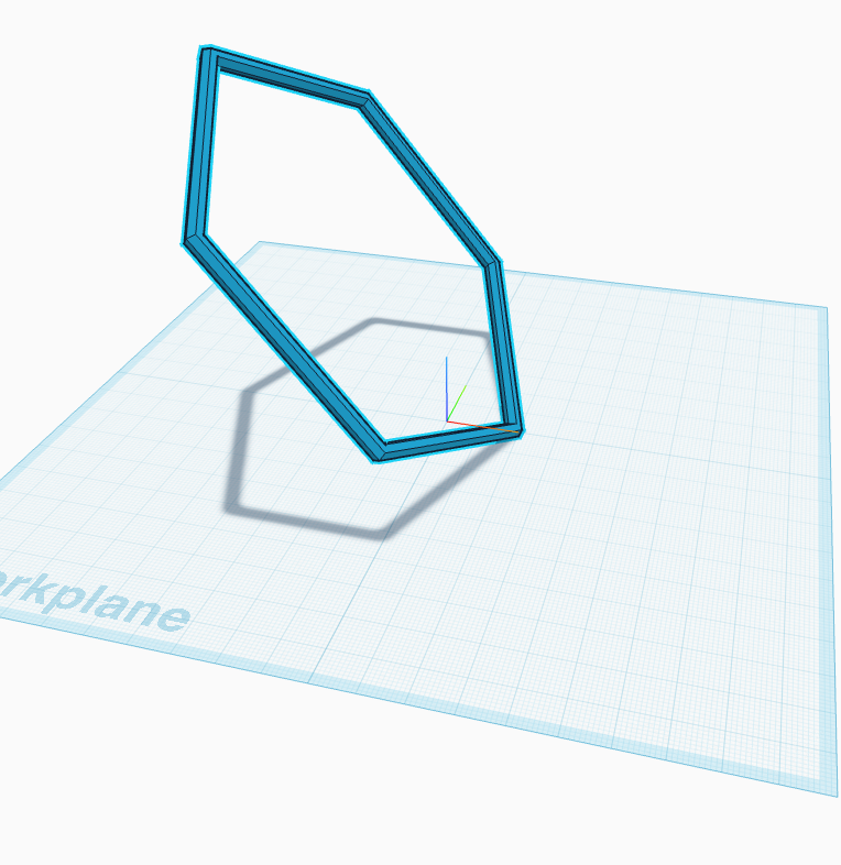 The tilted hexagon standing on the workplane, off to one side.