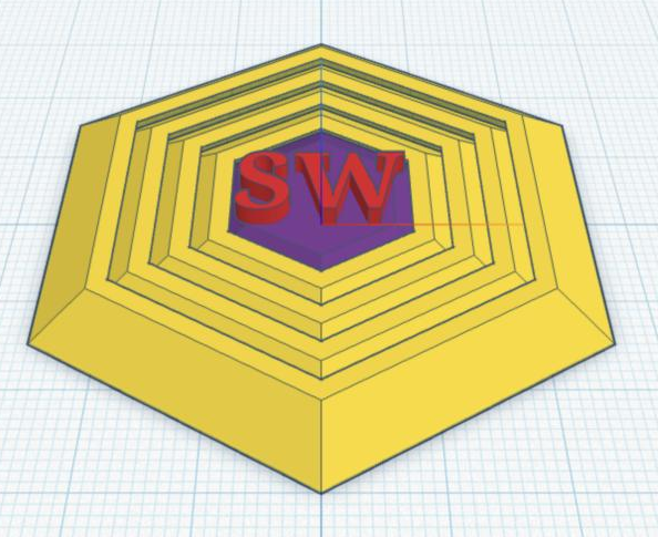 The fidget center with raised initials on its face.