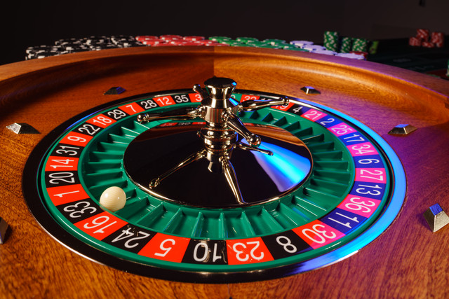 A real roulette wheel with the ball resting in a pocket.
