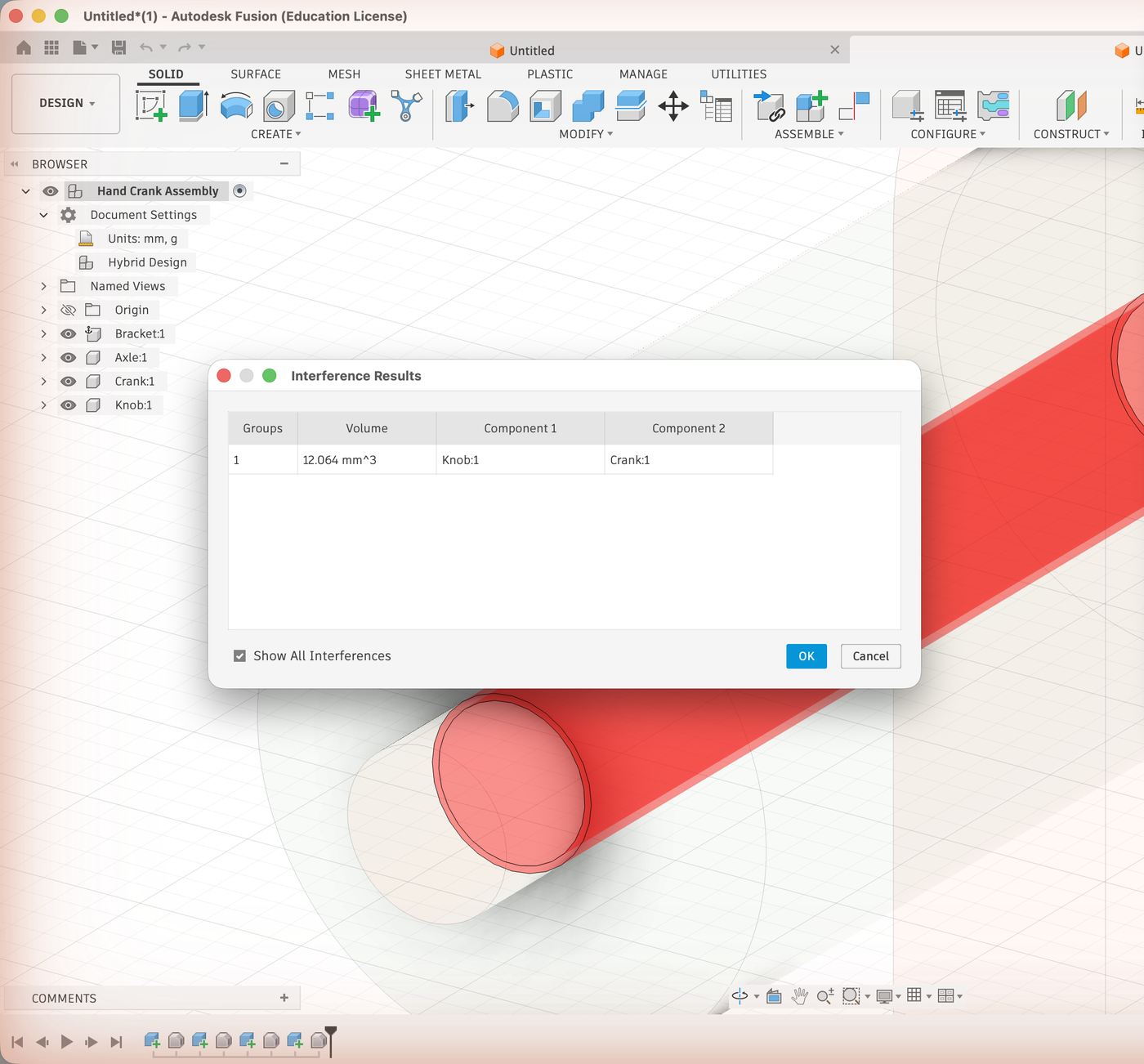 The Interference Results dialog listing one group: Knob and Crank overlap by 12.064 cubic millimeters, with the overlap shown in red behind it.